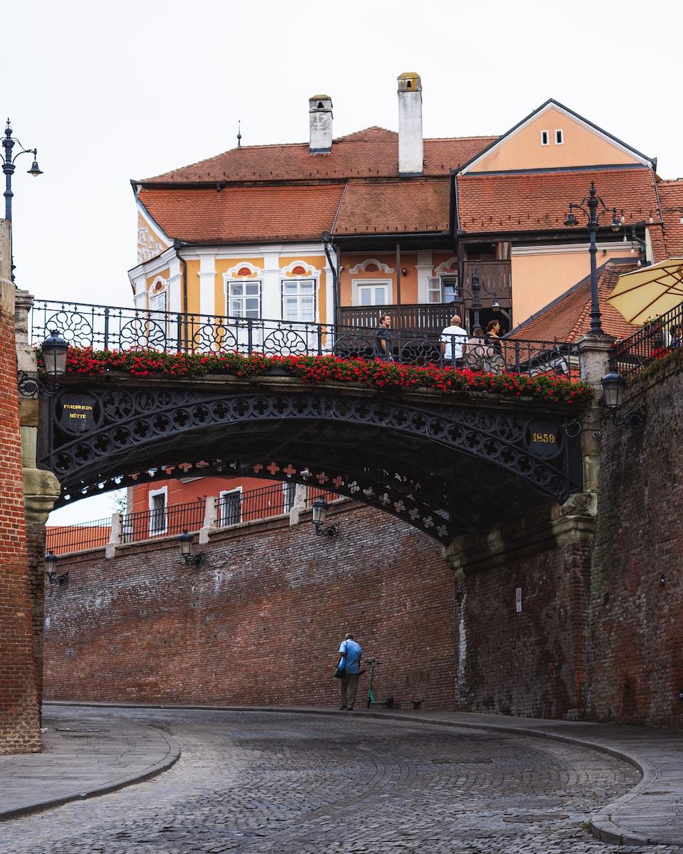 Photo by Traian Titilincu a bridge with a building in the background