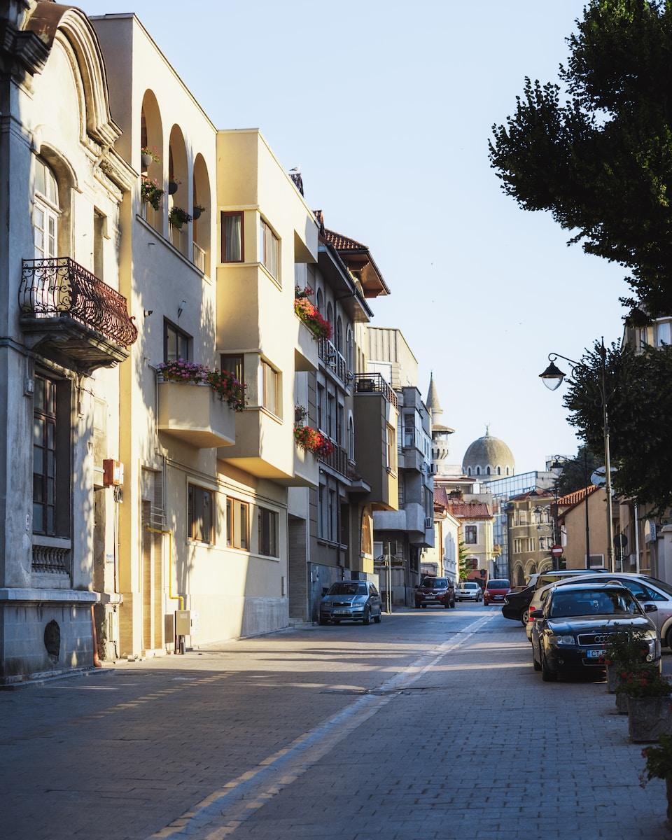Photo by Traian Titilincu a street with cars parked on the side