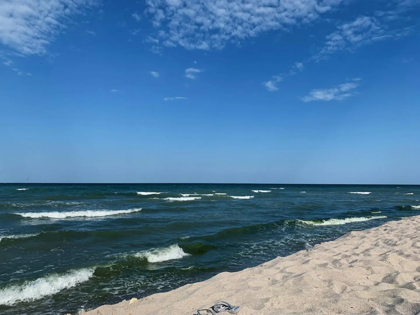 Photo by Diana ✨ Vivid blue sky with clouds above light beige sandy coast of dark blue wavy endless sea in sunlight