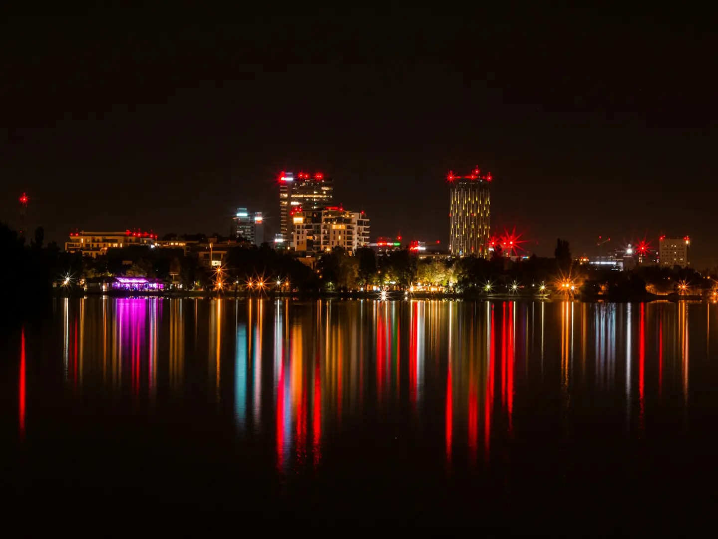Photo by Liviu Emanuel city skyline during night time