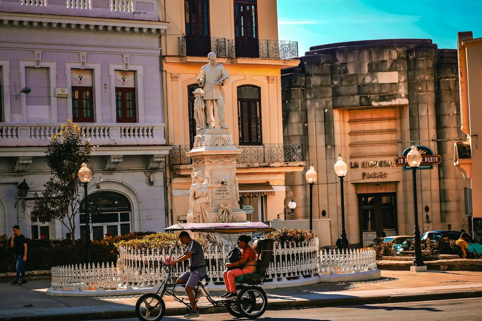 Photo by Meg von Haartman Colorful buildings and a statue in a city square.