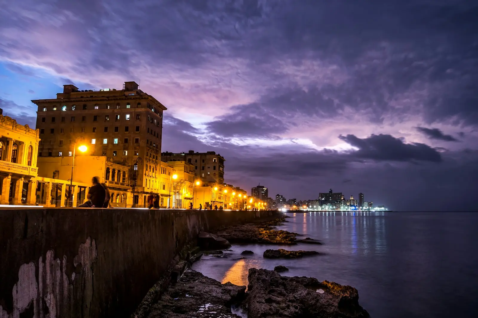 Photo by Toomas Tartes lighted post lamps near sea during night