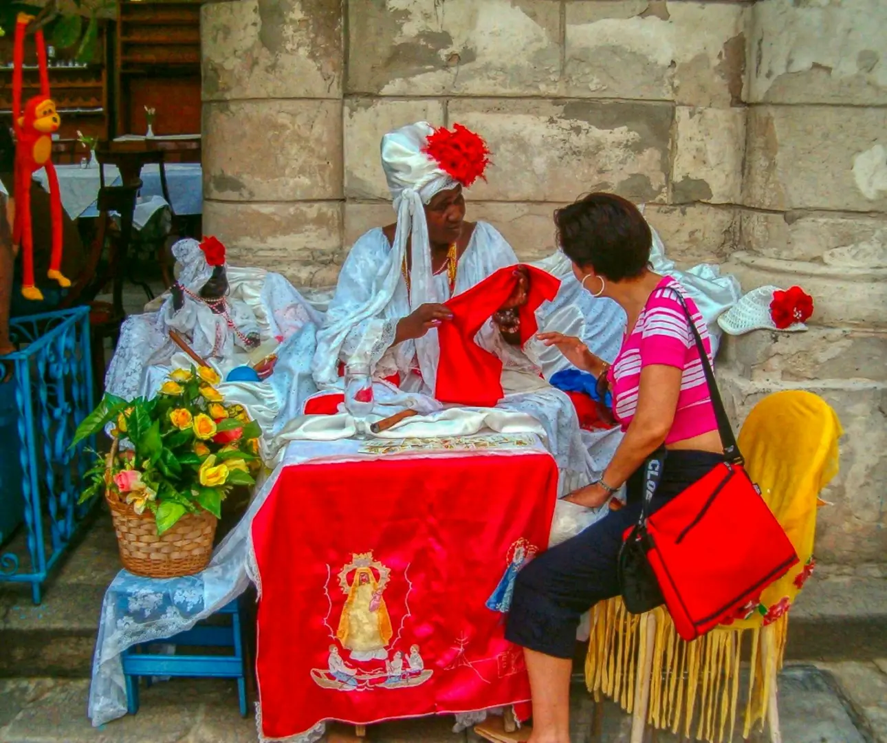 Photo by Jobove Reus Woman interacts with vendor in traditional attire